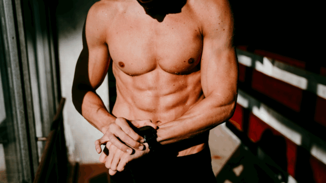 Example of a shredded male body achieved through training and mindset Male athlete with lean abs showing a ten percent body fat level